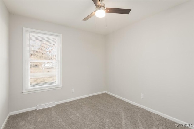 unfurnished room featuring ceiling fan and carpet flooring