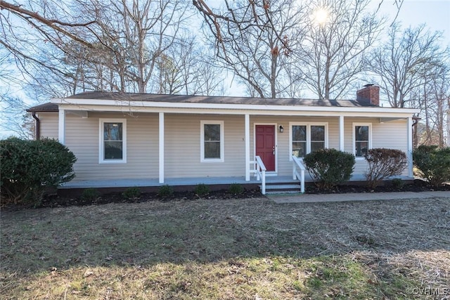 ranch-style house with a front yard and a porch