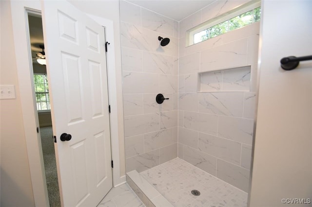 bathroom with baseboards, a shower stall, and marble finish floor