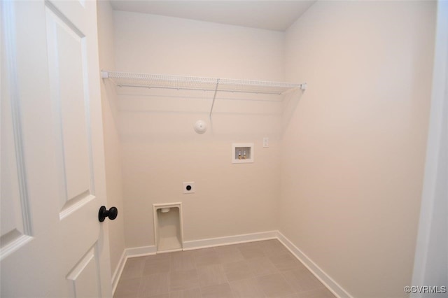 laundry area featuring washer hookup, laundry area, tile patterned floors, baseboards, and electric dryer hookup