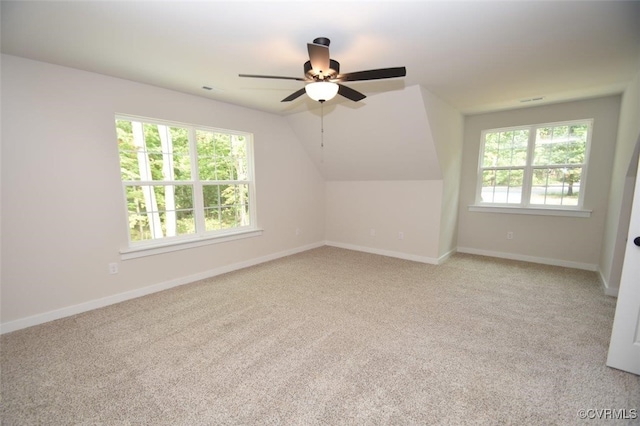 bonus room with ceiling fan, vaulted ceiling, and light carpet