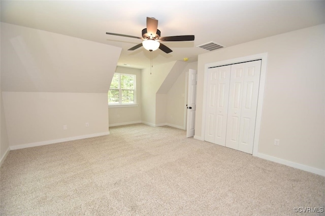 bonus room featuring lofted ceiling, light colored carpet, and ceiling fan