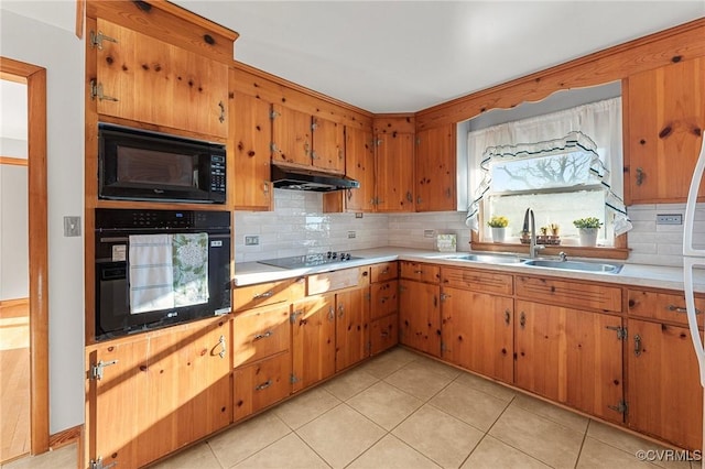 kitchen featuring light tile patterned flooring, sink, decorative backsplash, and black appliances