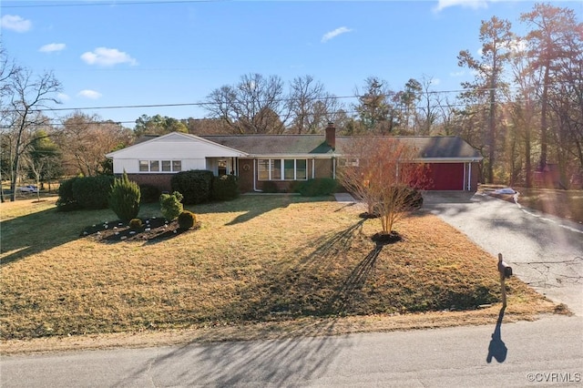 ranch-style house with a garage and a front yard