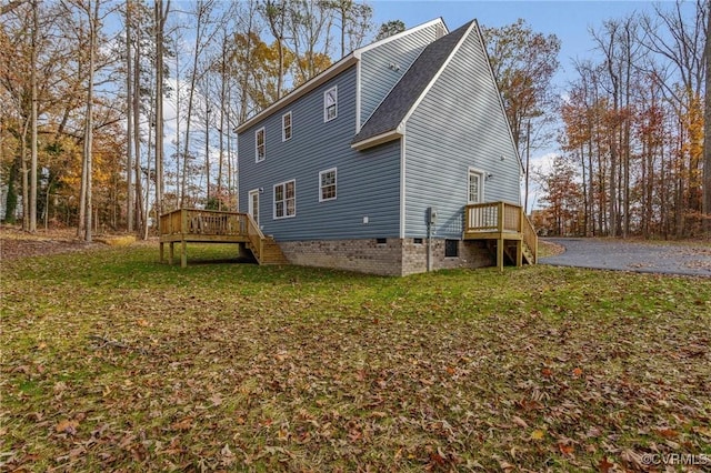 back of house featuring a yard and a deck