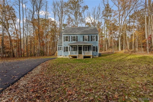 colonial inspired home with covered porch and a front lawn