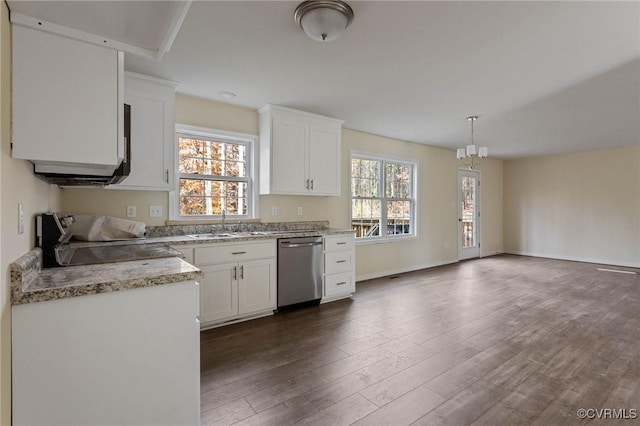 kitchen featuring sink, dishwasher, stove, pendant lighting, and white cabinets