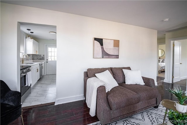 living room featuring sink and dark hardwood / wood-style floors