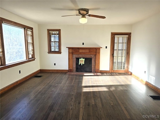 unfurnished living room with hardwood / wood-style flooring, ceiling fan, and a fireplace