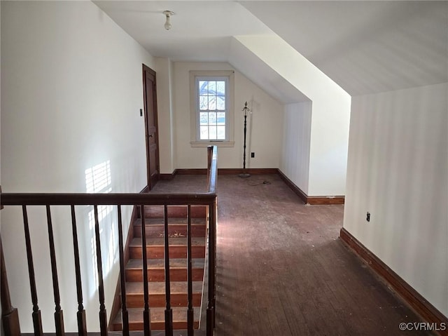 additional living space featuring dark wood-type flooring and lofted ceiling