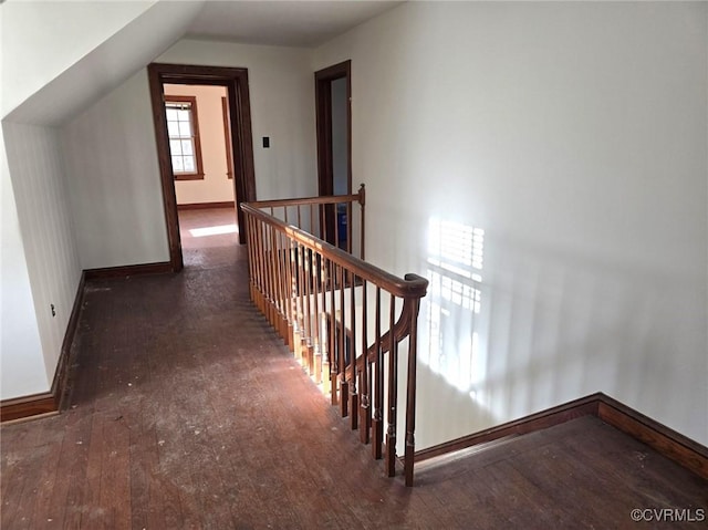 interior space featuring dark hardwood / wood-style flooring and lofted ceiling