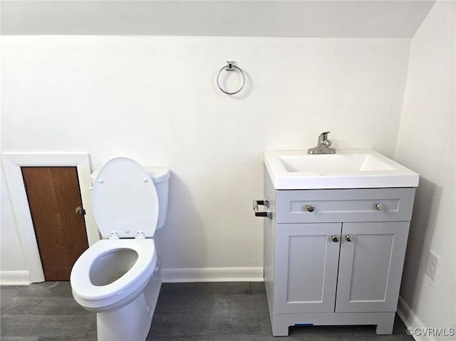 bathroom with vanity, wood-type flooring, and toilet