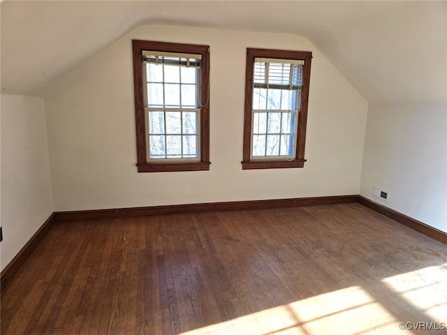 additional living space with lofted ceiling and dark wood-type flooring