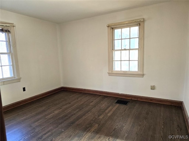 spare room with dark hardwood / wood-style flooring