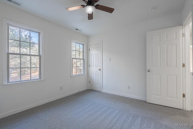 spare room featuring ceiling fan and carpet flooring