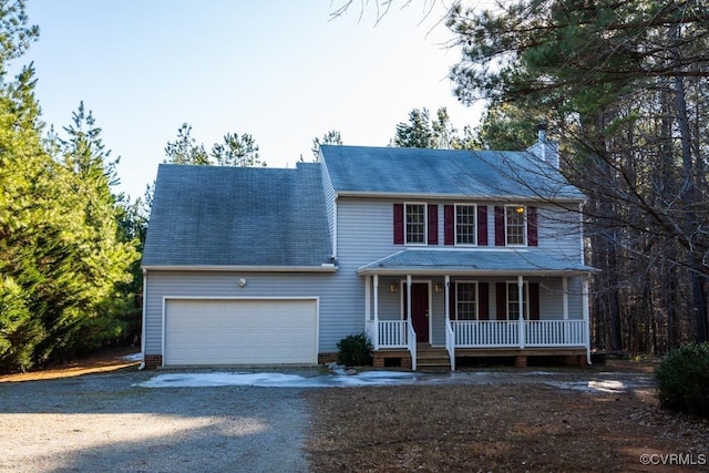 colonial-style house featuring a porch and a garage