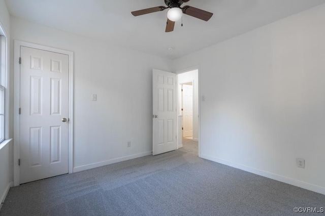 unfurnished room with ceiling fan and carpet floors