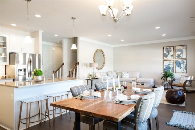 dining room with ornamental molding, dark wood-type flooring, and an inviting chandelier