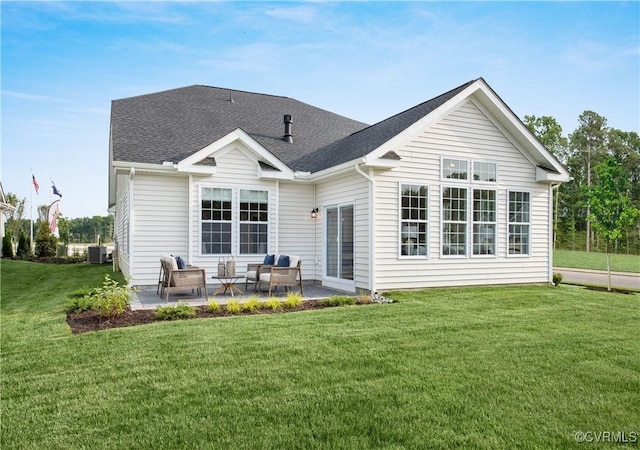 rear view of house featuring cooling unit, a yard, and a patio