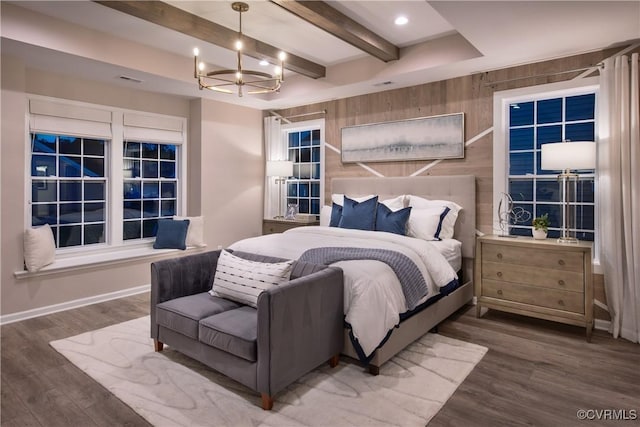 bedroom featuring beamed ceiling, an inviting chandelier, dark hardwood / wood-style flooring, and wood walls