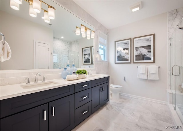 bathroom with vanity, a shower with shower door, and toilet