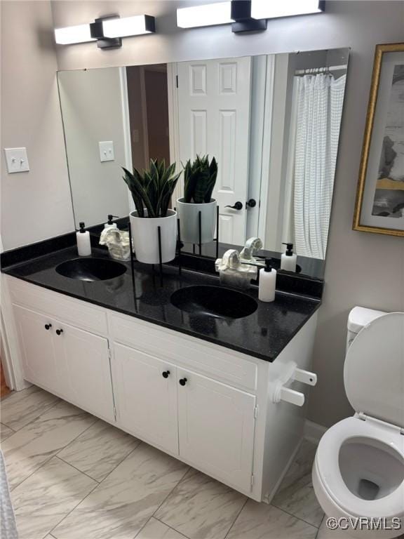 bathroom featuring vanity and toilet