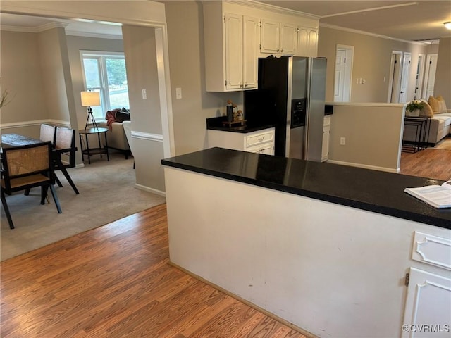 kitchen with crown molding, stainless steel fridge, light hardwood / wood-style floors, and white cabinets