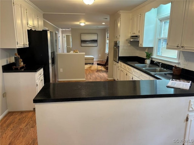 kitchen with stainless steel appliances, white cabinetry, and kitchen peninsula