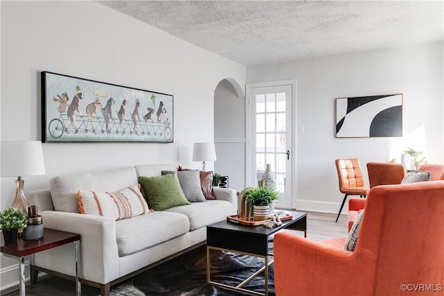 living room with hardwood / wood-style floors and a textured ceiling