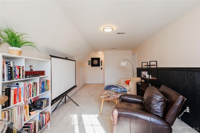 interior space with lofted ceiling and light colored carpet