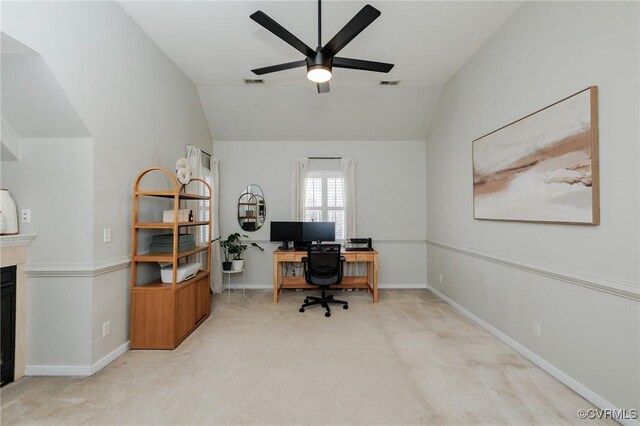 carpeted office space with lofted ceiling and ceiling fan