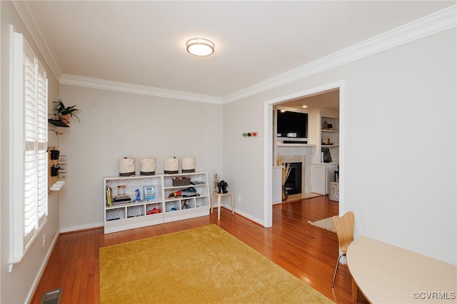 interior space with hardwood / wood-style flooring and ornamental molding