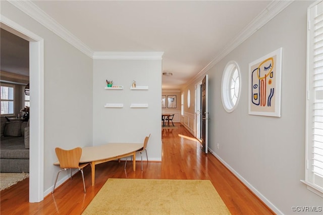 hallway with ornamental molding and hardwood / wood-style floors