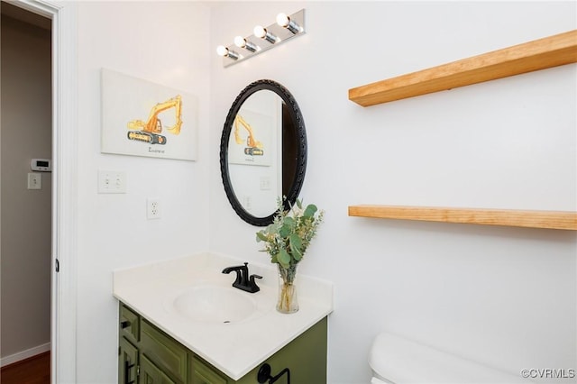 bathroom featuring vanity and toilet