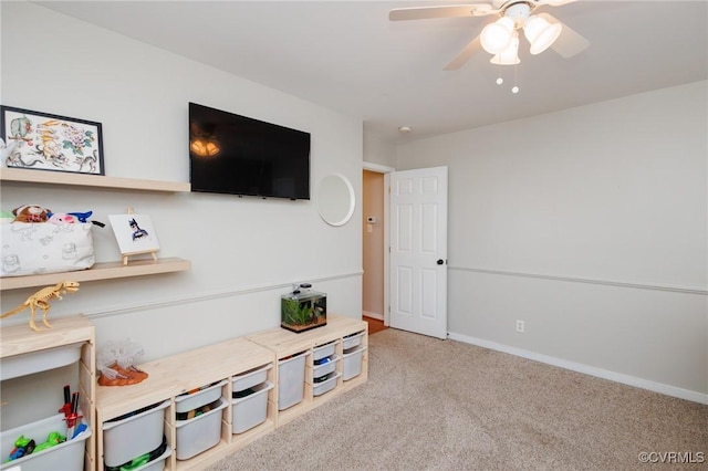 game room with ceiling fan and light colored carpet