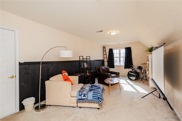 carpeted living room featuring vaulted ceiling