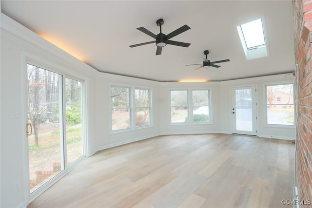 unfurnished sunroom featuring a skylight