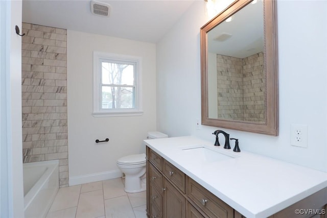 bathroom with toilet, vanity, and tile patterned flooring