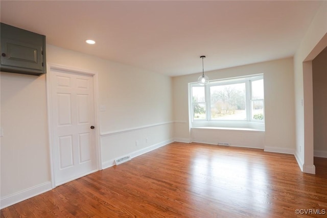 unfurnished dining area featuring hardwood / wood-style flooring