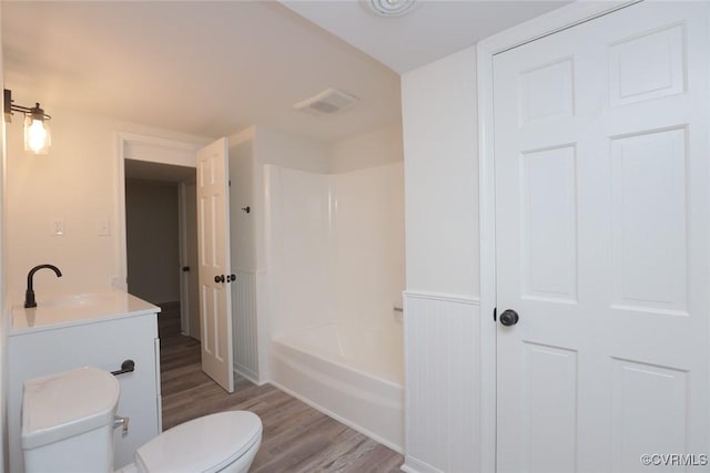 bathroom featuring hardwood / wood-style flooring, vanity, and toilet