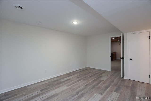 spare room with light hardwood / wood-style floors