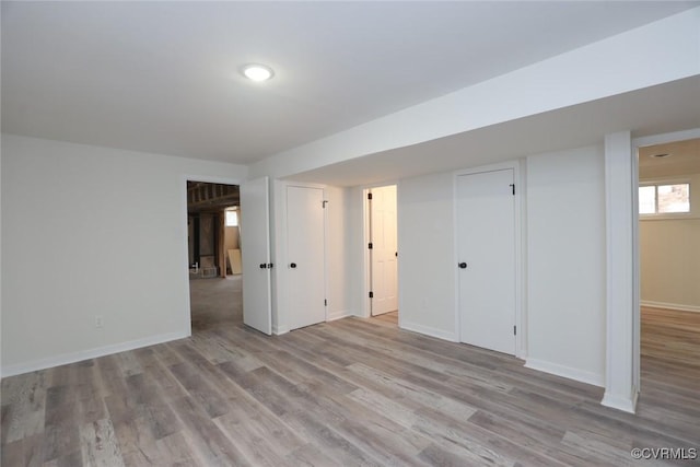 basement with light hardwood / wood-style floors