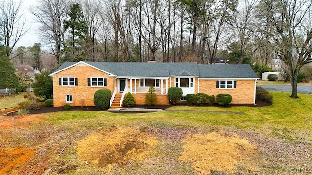 single story home featuring a porch and a front yard