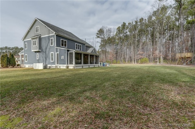 exterior space with a sunroom and a yard