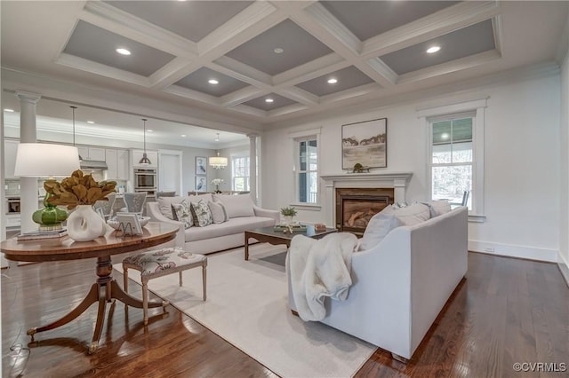 living room with coffered ceiling, crown molding, a high end fireplace, and beamed ceiling