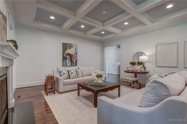 living room with hardwood / wood-style flooring, coffered ceiling, a premium fireplace, and beamed ceiling