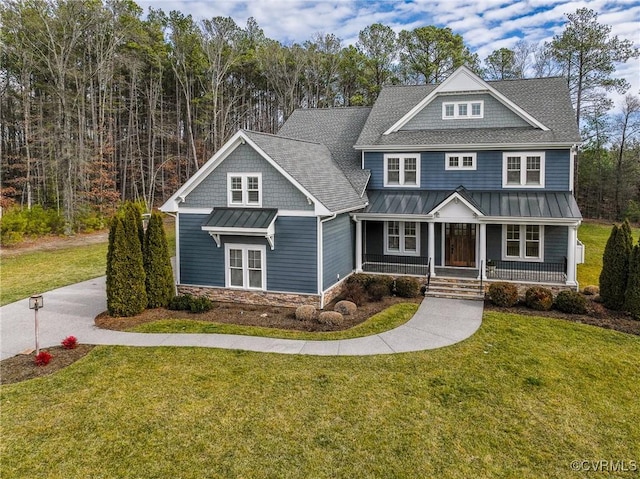 craftsman inspired home featuring a porch and a front yard