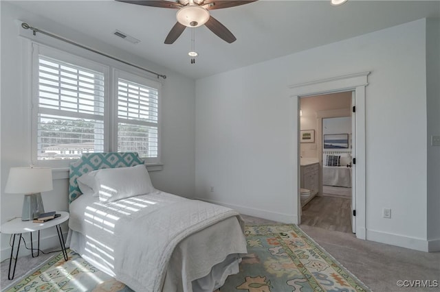 bedroom with light carpet and ensuite bathroom