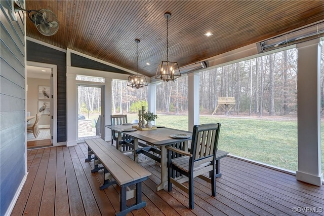 sunroom featuring lofted ceiling, wood ceiling, and an inviting chandelier