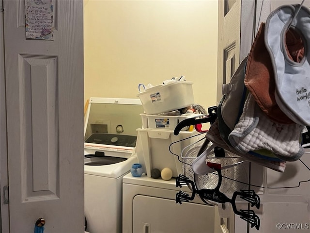 clothes washing area with washer and clothes dryer